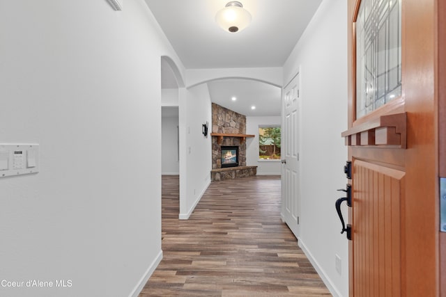 5519 N Wade St, Coeur Dalene, ID 83815 - entryway featuring wood finished floors, arched walkways, baseboards, and a fireplace