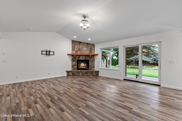 5519 N Wade St, Coeur Dalene, ID 83815 - unfurnished living room featuring wood finished floors, vaulted ceiling, baseboards, and a fireplace
