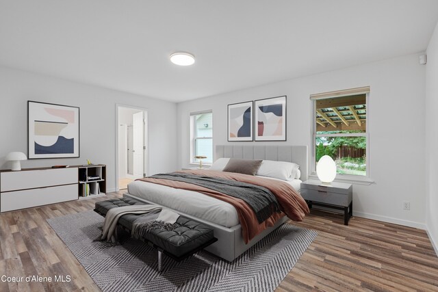 5519 N Wade St, Coeur Dalene, ID 83815 - bedroom featuring wood finished floors, baseboards, and ensuite bathroom
