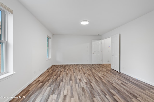 5519 N Wade St, Coeur Dalene, ID 83815 - unfurnished room featuring wood finished floors, healthy amount of natural light, and baseboards