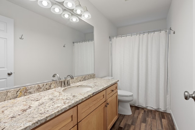 5519 N Wade St, Coeur Dalene, ID 83815 - full bathroom with wood finished floors, vanity, toilet, and a shower with shower curtain