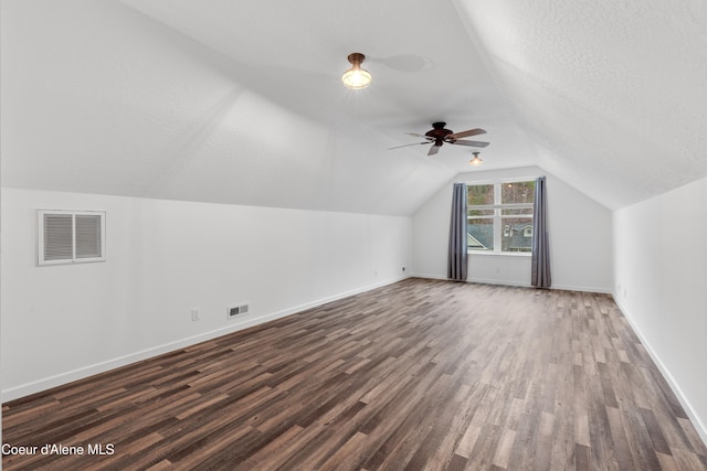 5519 N Wade St, Coeur Dalene, ID 83815 - additional living space featuring dark wood-type flooring, lofted ceiling, baseboards, ceiling fan, and a textured ceiling