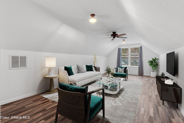 5519 N Wade St, Coeur Dalene, ID 83815 - living area with wood finished floors, vaulted ceiling, baseboards, ceiling fan, and a textured ceiling