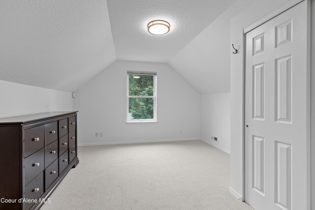 5519 N Wade St, Coeur Dalene, ID 83815 - bonus room with a textured ceiling, light colored carpet, lofted ceiling, and baseboards