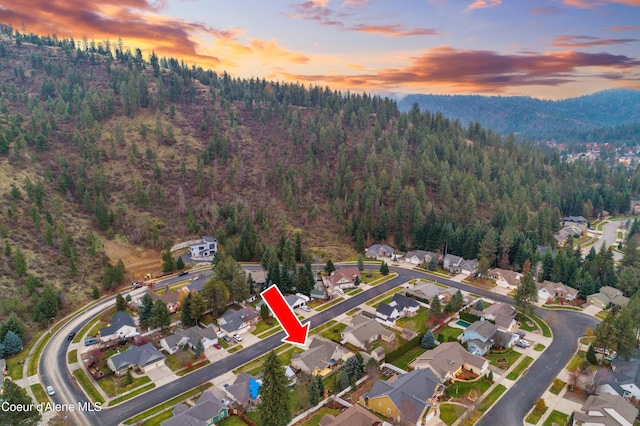 5519 N Wade St, Coeur Dalene, ID 83815 - aerial overview of property's location with a forest, nearby suburban area, and mountains