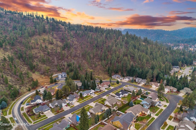 5519 N Wade St, Coeur Dalene, ID 83815 - aerial view of property and surrounding area with a forest, nearby suburban area, and mountains