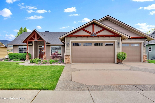 14097 N Pristine Cir, Rathdrum, ID 83858 - craftsman-style house with concrete driveway, stone siding, an attached garage, and a front yard