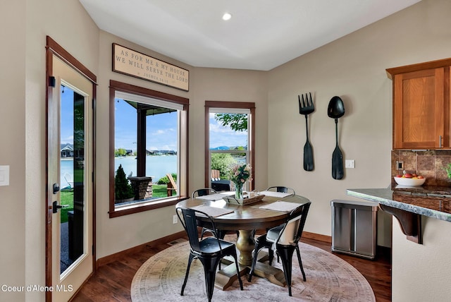 14097 N Pristine Cir, Rathdrum, ID 83858 - dining space featuring dark wood finished floors, a water view, baseboards, and recessed lighting