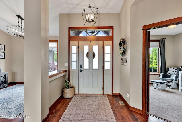 14097 N Pristine Cir, Rathdrum, ID 83858 - foyer featuring a chandelier, dark wood-style floors, a towering ceiling, and baseboards