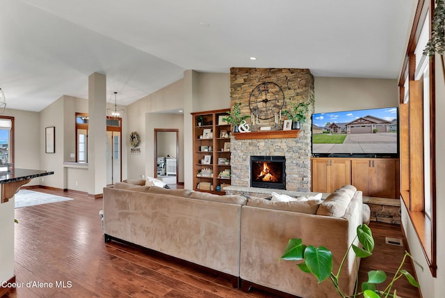 14097 N Pristine Cir, Rathdrum, ID 83858 - living area with dark wood-type flooring, a stone fireplace, baseboards, and high vaulted ceiling
