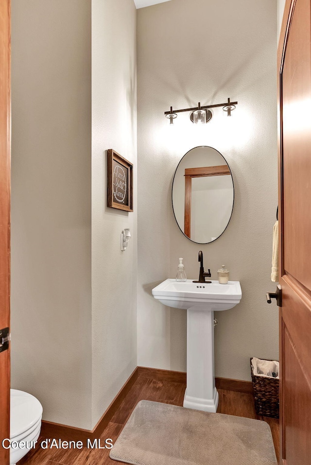 14097 N Pristine Cir, Rathdrum, ID 83858 - bathroom with wood finished floors, baseboards, and toilet