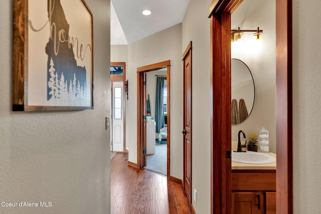 14097 N Pristine Cir, Rathdrum, ID 83858 - hallway featuring wood finished floors, a sink, recessed lighting, and baseboards
