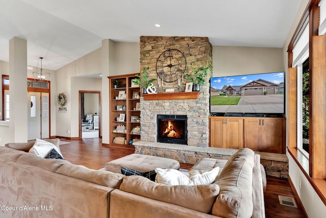 14097 N Pristine Cir, Rathdrum, ID 83858 - living area featuring healthy amount of natural light, dark wood finished floors, a fireplace, high vaulted ceiling, and a chandelier