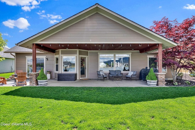14097 N Pristine Cir, Rathdrum, ID 83858 - back of property with a lawn and a patio area
