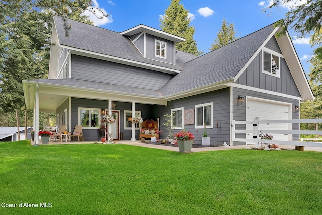 17940 W Sheltered Ct, Hauser, ID 83854 - rear view of house with a yard, a shingled roof, and board and batten siding