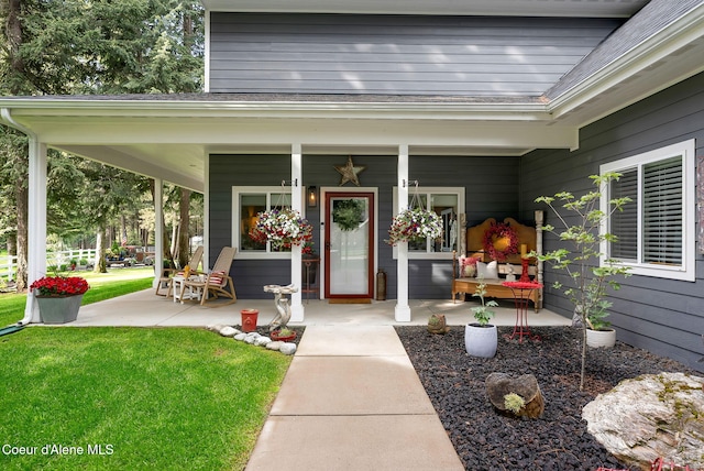 17940 W Sheltered Ct, Hauser, ID 83854 - doorway to property featuring a porch and a lawn