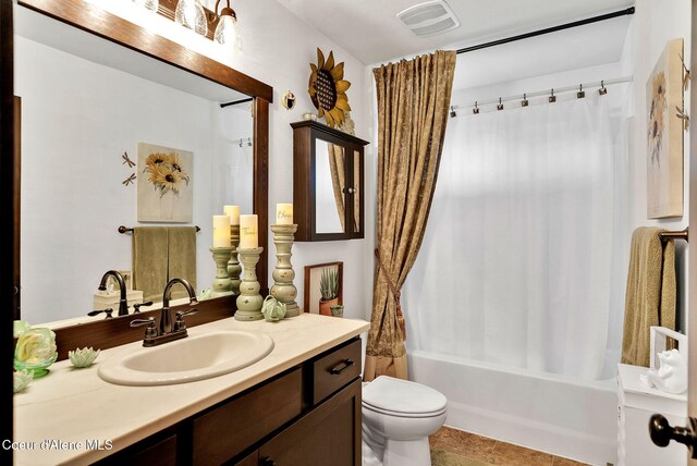 17940 W Sheltered Ct, Hauser, ID 83854 - full bathroom with vanity, toilet, shower / bath combo with shower curtain, and tile patterned flooring