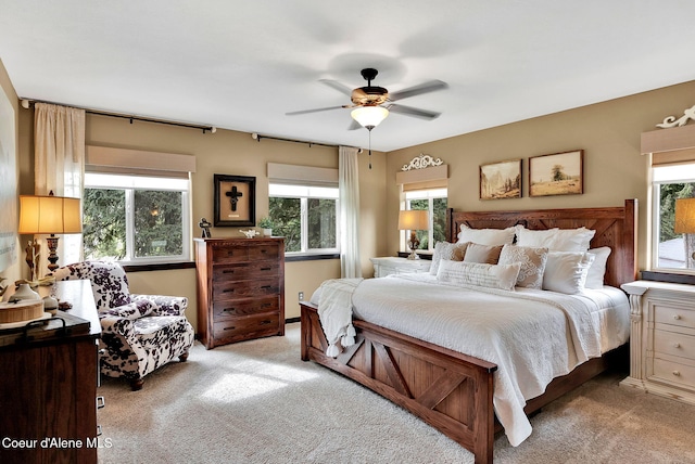 17940 W Sheltered Ct, Hauser, ID 83854 - bedroom featuring light colored carpet and a ceiling fan