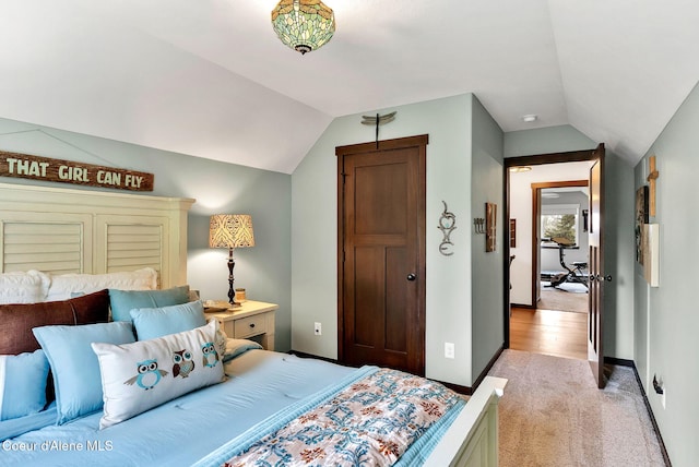 17940 W Sheltered Ct, Hauser, ID 83854 - bedroom featuring vaulted ceiling, light carpet, and baseboards