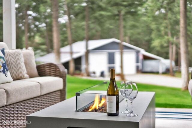 17940 W Sheltered Ct, Hauser, ID 83854 - view of patio / terrace featuring an outdoor living space with a fire pit