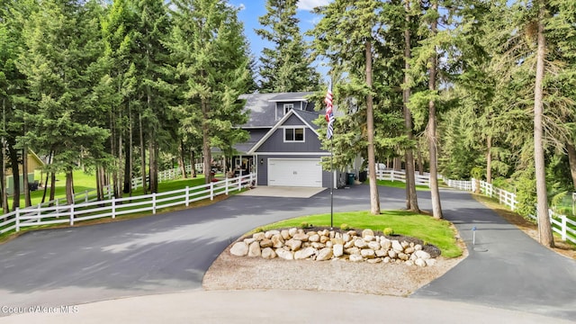 17940 W Sheltered Ct, Hauser, ID 83854 - view of front of house featuring driveway, an attached garage, and board and batten siding