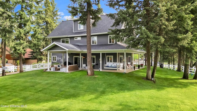 17940 W Sheltered Ct, Hauser, ID 83854 - back of house with an outdoor living space, a patio, and a shingled roof