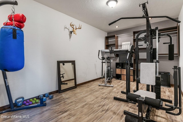 603 Schneiders Rd, Sagle, ID 83860 - exercise room featuring wood finished floors, baseboards, a textured ceiling, and recessed lighting