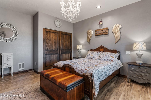 603 Schneiders Rd, Sagle, ID 83860 - bedroom featuring wood finished floors, baseboards, a chandelier, and a closet