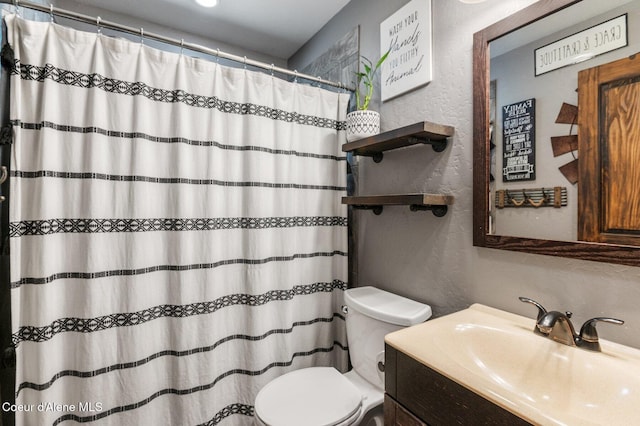 603 Schneiders Rd, Sagle, ID 83860 - bathroom with a textured wall, toilet, vanity, and a shower with curtain