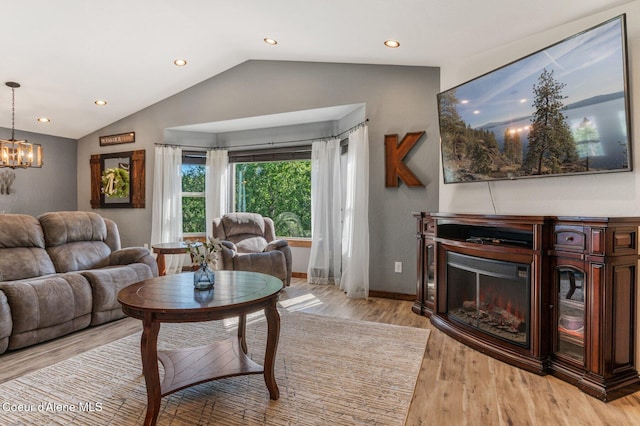 603 Schneiders Rd, Sagle, ID 83860 - living area with lofted ceiling, a glass covered fireplace, light wood finished floors, a chandelier, and recessed lighting