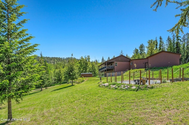 603 Schneiders Rd, Sagle, ID 83860 - view of green lawn with a vegetable garden and a wooded view