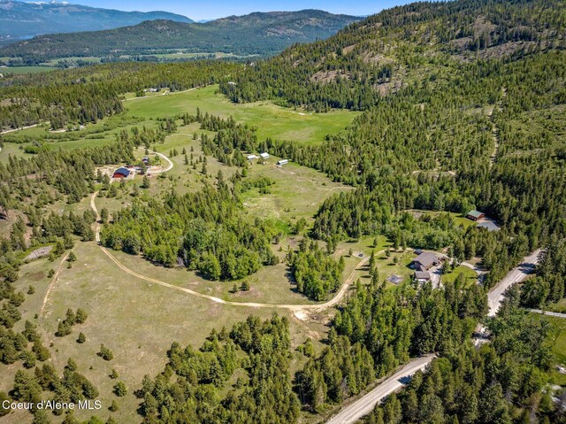 603 Schneiders Rd, Sagle, ID 83860 - aerial view of property's location with a heavily wooded area and a mountainous background