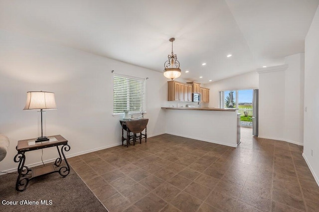 13458 N Bighorn Canyon St, Rathdrum, ID 83858 - kitchen featuring appliances with stainless steel finishes, a peninsula, vaulted ceiling, light brown cabinetry, and recessed lighting