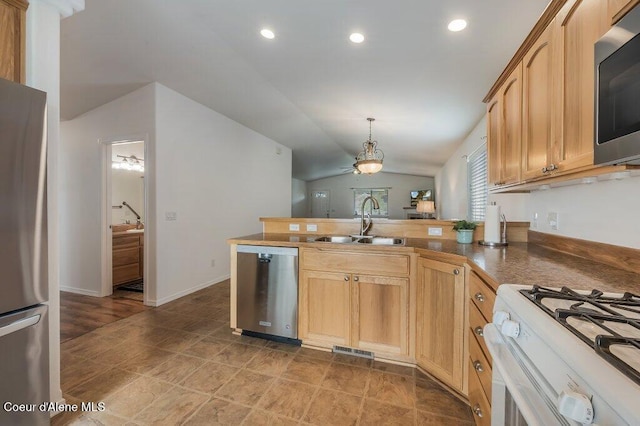 13458 N Bighorn Canyon St, Rathdrum, ID 83858 - kitchen with stainless steel appliances, a sink, vaulted ceiling, a peninsula, and ceiling fan