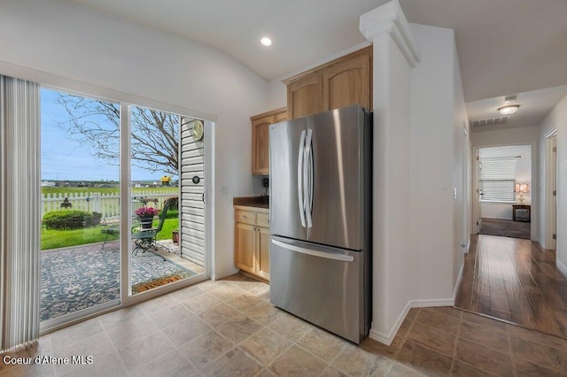 13458 N Bighorn Canyon St, Rathdrum, ID 83858 - kitchen with freestanding refrigerator, baseboards, vaulted ceiling, and recessed lighting