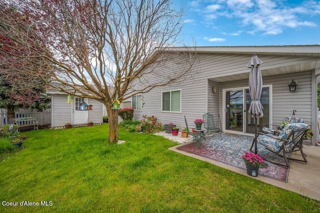 13458 N Bighorn Canyon St, Rathdrum, ID 83858 - view of green lawn featuring a patio area and an outdoor structure