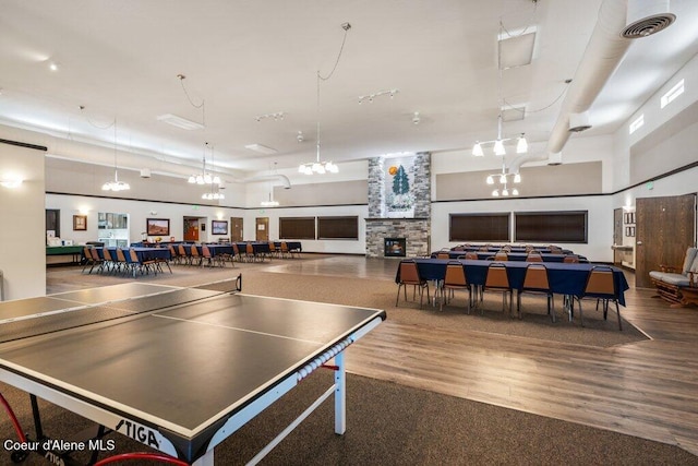 13458 N Bighorn Canyon St, Rathdrum, ID 83858 - game room featuring wood finished floors, a chandelier, and a fireplace