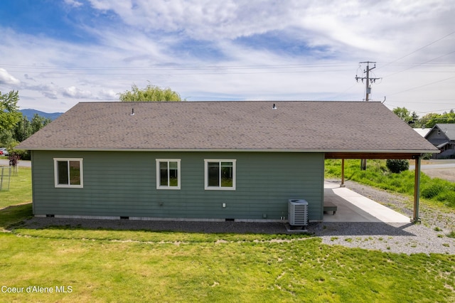 329 N 20th, Saint Maries, ID 83861 - rear view of house featuring central air condition unit, a patio area, a lawn, and a shingled roof