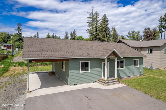 329 N 20th, Saint Maries, ID 83861 - view of front of home featuring crawl space, asphalt driveway, a carport, a front lawn, and roof with shingles