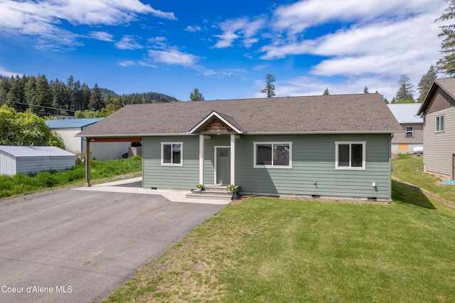 329 N 20th, Saint Maries, ID 83861 - view of front of home featuring asphalt driveway, crawl space, a front lawn, and a carport