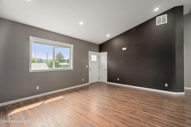 329 N 20th, Saint Maries, ID 83861 - empty room featuring wood finished floors, vaulted ceiling, baseboards, and recessed lighting