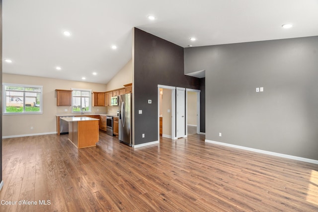 329 N 20th, Saint Maries, ID 83861 - kitchen featuring open floor plan, stainless steel appliances, a center island, light countertops, and high vaulted ceiling