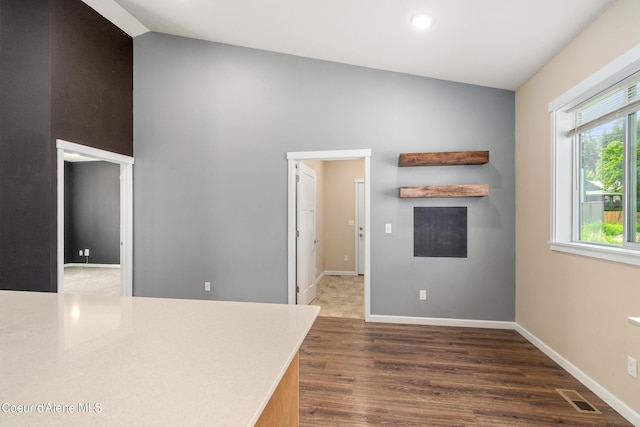 329 N 20th, Saint Maries, ID 83861 - spare room featuring dark wood-type flooring, baseboards, high vaulted ceiling, and recessed lighting