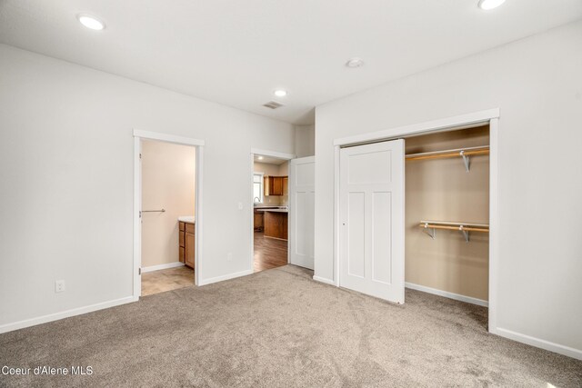 329 N 20th, Saint Maries, ID 83861 - unfurnished bedroom with a closet, carpet flooring, recessed lighting, baseboards, and ensuite bath
