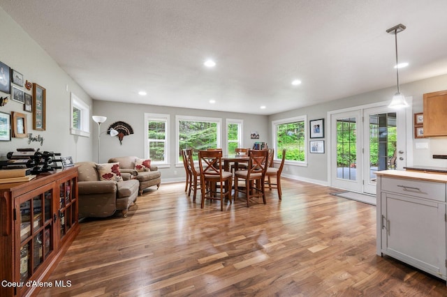 dining room featuring wood finished floors, recessed lighting, and baseboards
