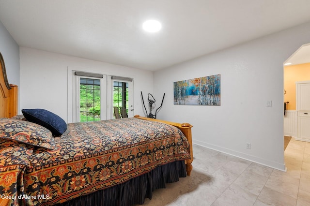 bedroom with access to exterior and baseboards