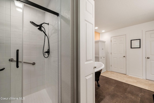 bathroom featuring a shower stall, recessed lighting, and a freestanding tub