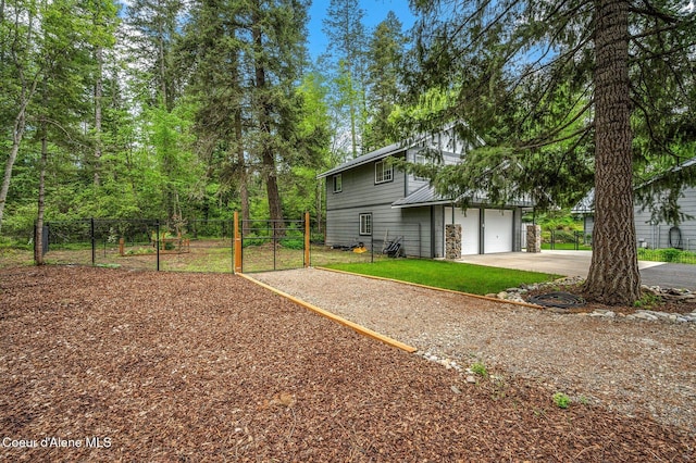 view of home's exterior with a garage, driveway, and stone siding