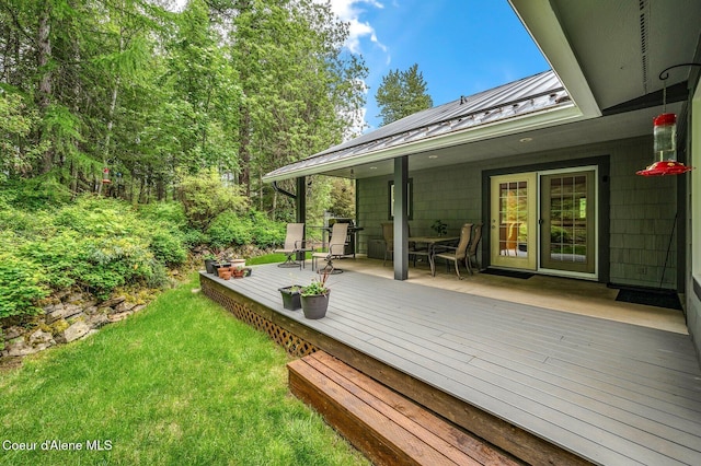 wooden deck with a lawn and area for grilling