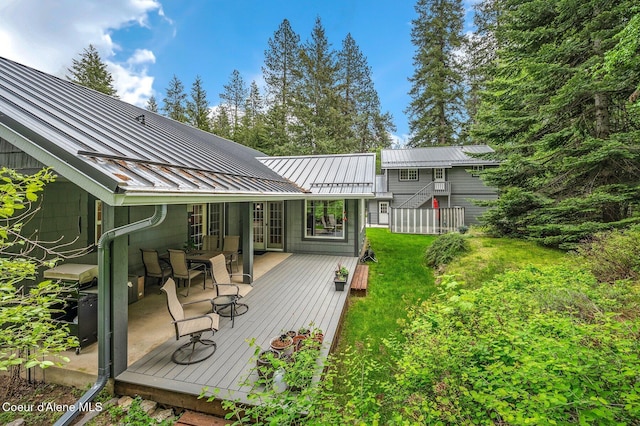 wooden terrace with a lawn